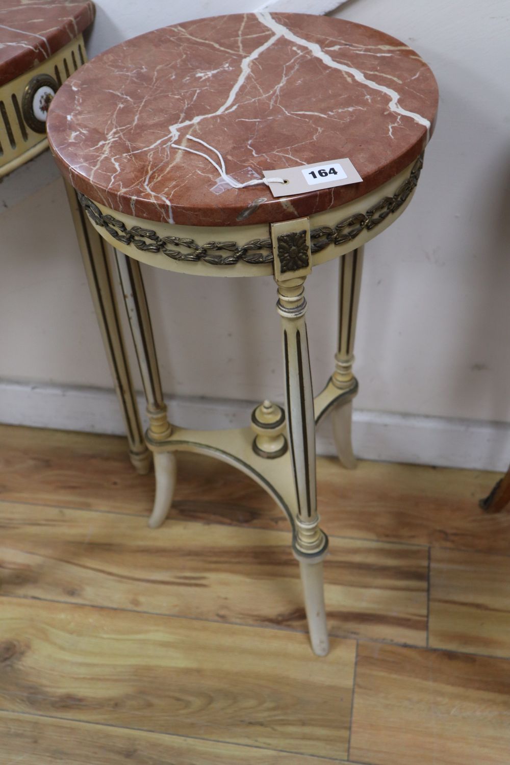 A pair of parcel gilt cream painted occasional tables with rouge marble tops and a similar demi-lune table with cracked marble top